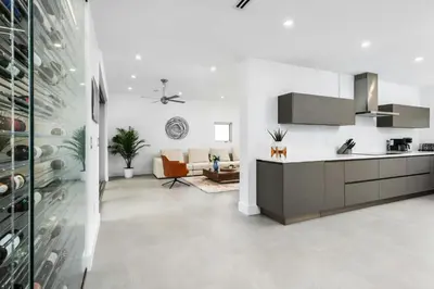 a kitchen with white walls and a living room at Villa Modern Miami glamour in Miami