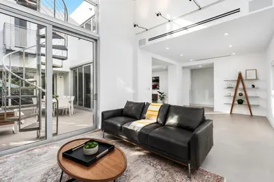 a living room with a black leather couch and a table at Villa Modern Miami glamour in Miami