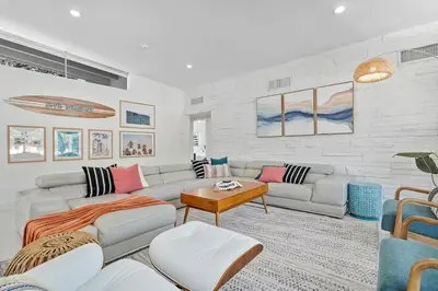 a living room with a couch and a table at 5BR Villa with Heated Pool, Firepit and 10mins to Beach in Highland Lakes