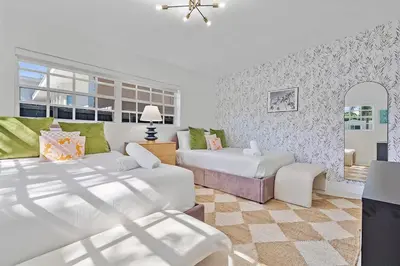 a living room with two beds and a couch at 5BR Villa with Heated Pool, Firepit and 10mins to Beach in Highland Lakes