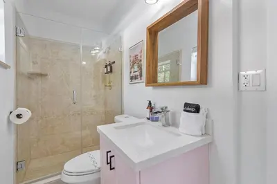 a bathroom with a toilet and a sink and a shower at 5BR Villa with Heated Pool, Firepit and 10mins to Beach in Highland Lakes