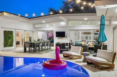 a swimming pool in a living room with a house at 5BR Villa with Heated Pool, Firepit and 10mins to Beach in Highland Lakes