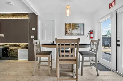 a kitchen with a table and chairs and a counter at Heated Pool Home - Mini Golf & Soccer & Firepit in Hollywood