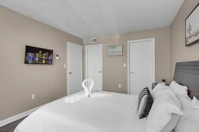 a bedroom with a bed with white sheets and pillows at Centrally Located 2 BED in the Heart of NMB in North Miami