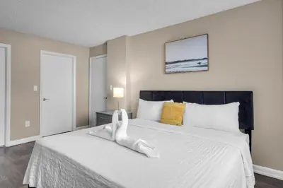 a bedroom with a bed with a towel animal on it at Centrally Located 2 BED in the Heart of NMB in North Miami
