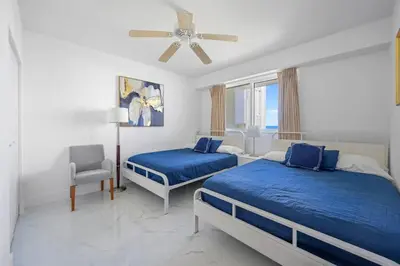 a bedroom with two beds and a ceiling fan at Stylish, classy Bayfront view apt, Walk to beach in Sunny Isles Beach