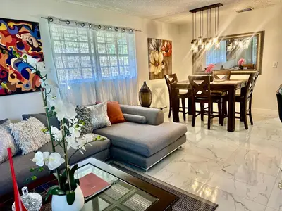 a living room with a couch and a dining room at Beach and Downtown Hollywood in Hollywood