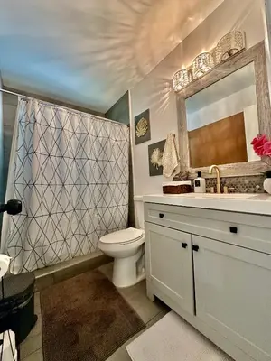 a bathroom with a toilet and a sink and a mirror at Beach and Downtown Hollywood in Hollywood