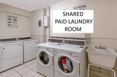 a laundry room with two washing machines and a sink at Oceanfront corner unit in Hollywood