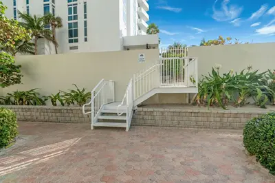a staircase leading up to a white building at Oceanfront corner unit in Hollywood