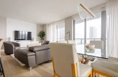 a living room with a couch and a table at Beachwalk Resort in Hallandale Beach