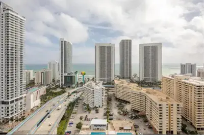 a city with tall buildings and a street with cars at Beachwalk Resort in Hallandale Beach