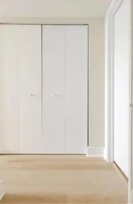 an empty room with white wardrobes at Beachwalk Resort in Hallandale Beach