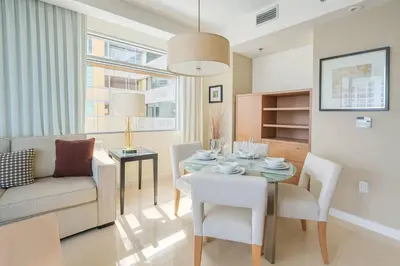 a living room with a table and a couch at AKA Hotel Stunning Views w- Free parking in Miami