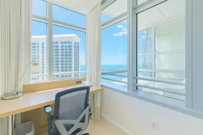 an office with a desk with a view of the ocean at AKA Hotel Stunning Views w- Free parking in Miami