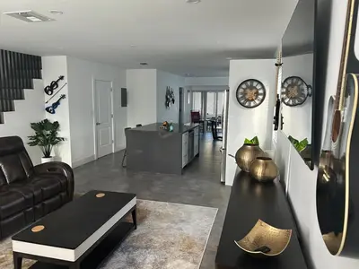 a living room with a couch and a table at 3-BDR Guitar House, Walk to Casino, located close to EVERYTHING! in Fort Lauderdale