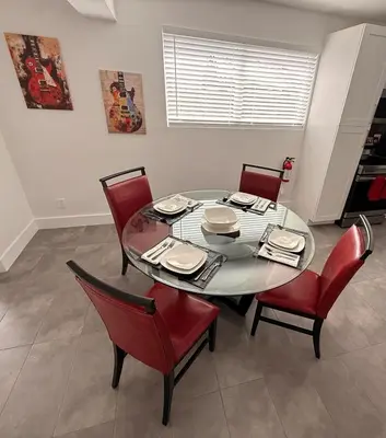 a dining room with a table and red chairs at 3-BDR Guitar House, Walk to Casino, located close to EVERYTHING! in Fort Lauderdale