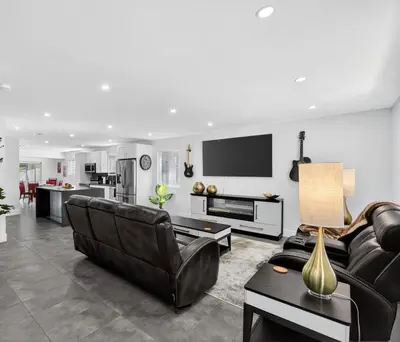 a living room with a couch and a tv at 3-BDR Guitar House, Walk to Casino, located close to EVERYTHING! in Fort Lauderdale