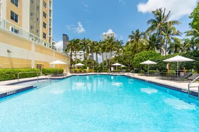 a large swimming pool in front of a building at Golden Bay 702 in Sunny Isles Beach