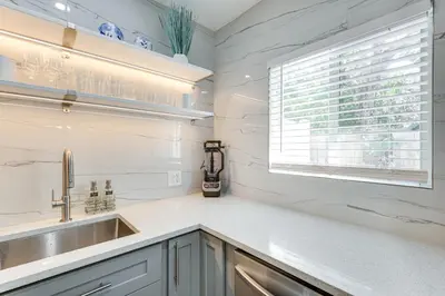 a kitchen with a sink and a window at 1 Mi to Las Olas Eats! Modern Apt with Shared Patio in Fort Lauderdale