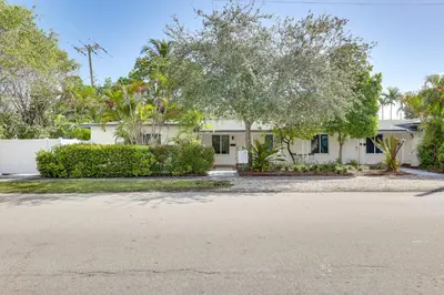 a house with trees in front of a street at 1 Mi to Las Olas Eats! Modern Apt with Shared Patio in Fort Lauderdale