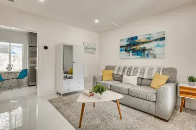 a living room with a couch and a table at Walk to Dining and Nightlife! Chic Apt Near Las Olas in Fort Lauderdale