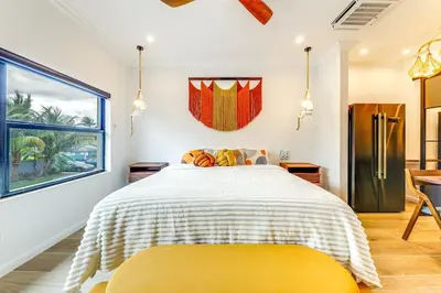 a bedroom with a bed with a yellow blanket at Home in Heart of Wilton Drive, 4 Mi to Beach in Fort Lauderdale