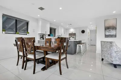 a dining room and kitchen with a table and chairs at Miami Private Pool Home 15 min to Beach - Aventura in Miami