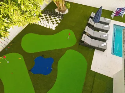 an overhead view of a golf course with a table and chairs at Miami Private Pool Home 15 min to Beach - Aventura in Miami
