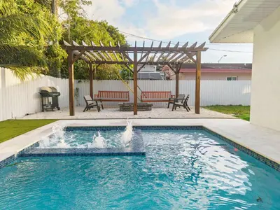 a swimming pool with a fountain in a yard at Miami Private Pool Home 15 min to Beach - Aventura in Miami
