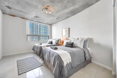 a bedroom with two beds and a window at Contemporary Midtown Condo - Pool & Free Parking in Miami