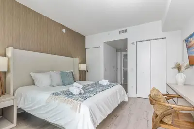 a bedroom with a bed with two stuffed animals on it at Luxurious Beachfront 2-Bedroom 2-Bathroom with balcony Condo at Lyft Resort & Residences - Miami Beach in Hollywood
