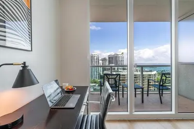 an office with a desk with a laptop and a balcony at Coconut Grove Bayview Retreat 2 King Suites Pool Gym and Free Parking in Miami