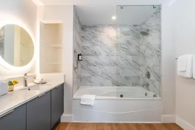 a white bathroom with a tub and a shower at Coconut Grove Bayview Retreat 2 King Suites Pool Gym and Free Parking in Miami