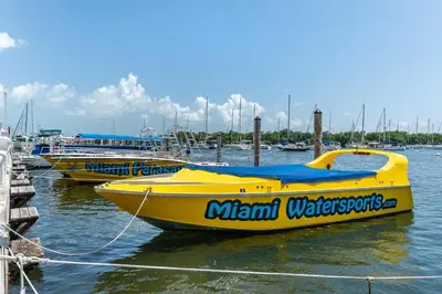three small yellow boats are docked in a marina at Elevated Grove Escape with Balcony & Bay Views-Includes Parking in Miami