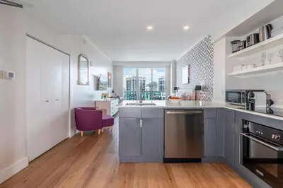 a kitchen with a sink and a counter top at Grove Bayview Getaway Stunning Views Pool Access & Parking in Miami