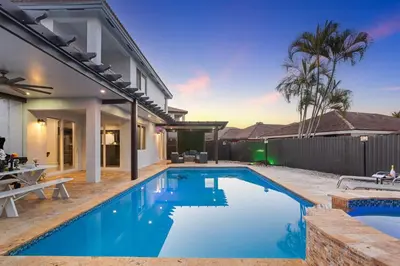 a swimming pool in the backyard of a house at Luxury 5BR Villa Private Pool I Jacuzzi I BBQ I Piano I Near Miami Airport in Kendale Lakes