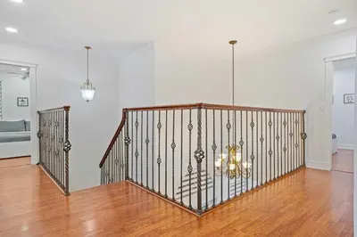 a room with a staircase with a chandelier at Luxury 5BR Villa Private Pool I Jacuzzi I BBQ I Piano I Near Miami Airport in Kendale Lakes