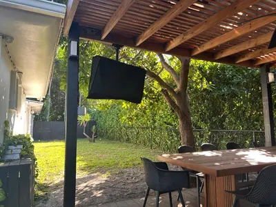 a table and chairs under a pergola at Luxury Miami home with heated pool & BBQ area, close to beaches & sports arenas in Miami