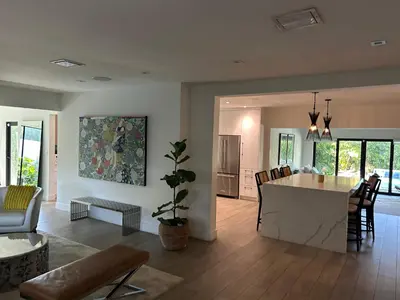 a kitchen and living room with a table and chairs at Luxury Miami home with heated pool & BBQ area, close to beaches & sports arenas in Miami