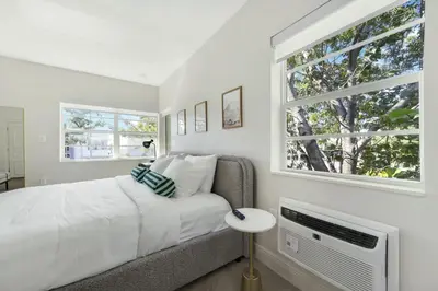 a bedroom with a bed and a window at The Lemon Branch Hotel in Miami Beach