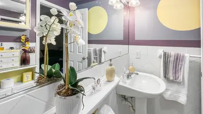 a bathroom with a white sink and a mirror at Ocean Front Studio - Miami Beach in Miami Beach