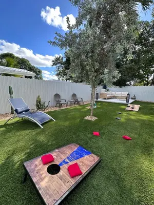 a backyard with a ping pong table and a tree at Oasis Yard -Pool-Jets-Game Room-BBQ-Relaxing in Carver Ranches
