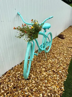 a blue bike with a basket filled with flowers at Oasis Yard -Pool-Jets-Game Room-BBQ-Relaxing in Carver Ranches