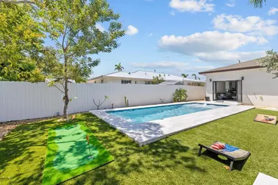 a swimming pool in the yard of a house at Oasis Yard -Pool-Jets-Game Room-BBQ-Relaxing in Carver Ranches