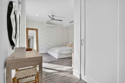a bedroom with a bed and a table with a mirror at Shoreline Villa by Rove - Rooftop & Beach Access in Hollywood