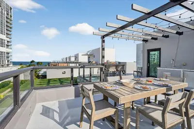 a table and chairs on a balcony with a view at Shoreline Villa by Rove - Rooftop & Beach Access in Hollywood