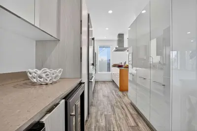 a kitchen with white cabinets and a counter top at Shoreline Villa by Rove - Rooftop & Beach Access in Hollywood