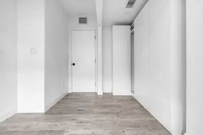 an empty hallway with white walls and a door at Contemporary Family Oasis Pool and Comfort in Miami