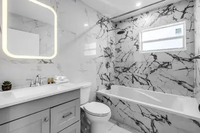a white bathroom with a black and white marble wall at Contemporary Family Oasis Pool and Comfort in Miami